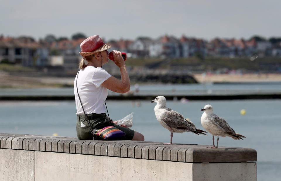 A woman on the seafront in Margate, Kent, as parts of the UK enjoy warm weather.