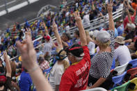 Fans hold up three fingers during a lap three tribute honoring the late Dale Earnhardt, Sr., during the NASCAR Daytona 500 auto race at Daytona International Speedway, Sunday, Feb. 14, 2021, in Daytona Beach, Fla. Dale Earnhardt, Sr., the all-time winner at Daytona, was killed in a fatal car crash at the speedway 20-years ago today. (AP Photo/Chris O'Meara)