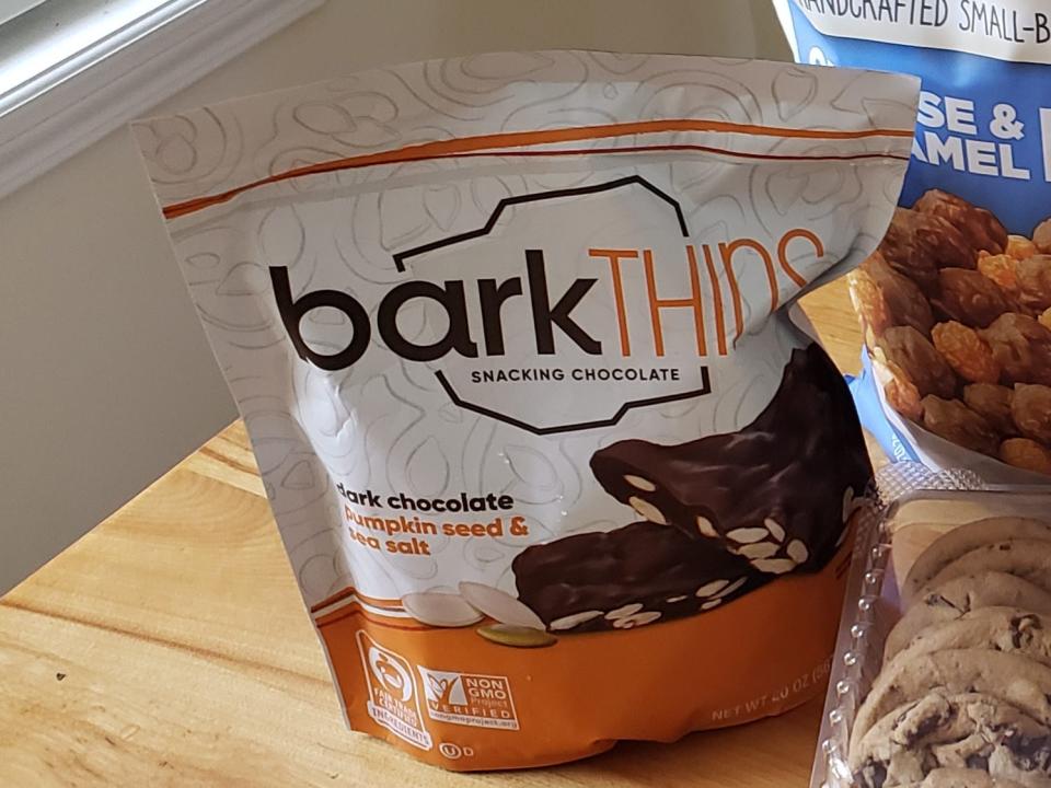 costco snack products sitting on a table, including barkthins