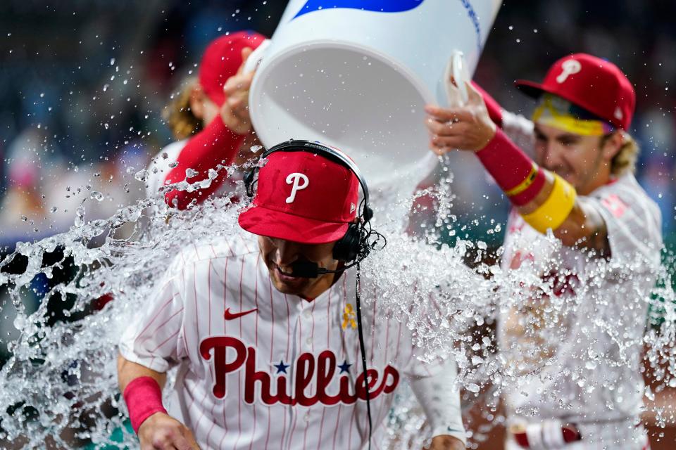 Philadelphia Phillies' Dalton Guthrie, center, is doused by Bryson Stott, right, and Alec Bohm after a baseball game against the Washington Nationals, Friday, Sept. 9, 2022, in Philadelphia. (AP Photo/Matt Slocum)