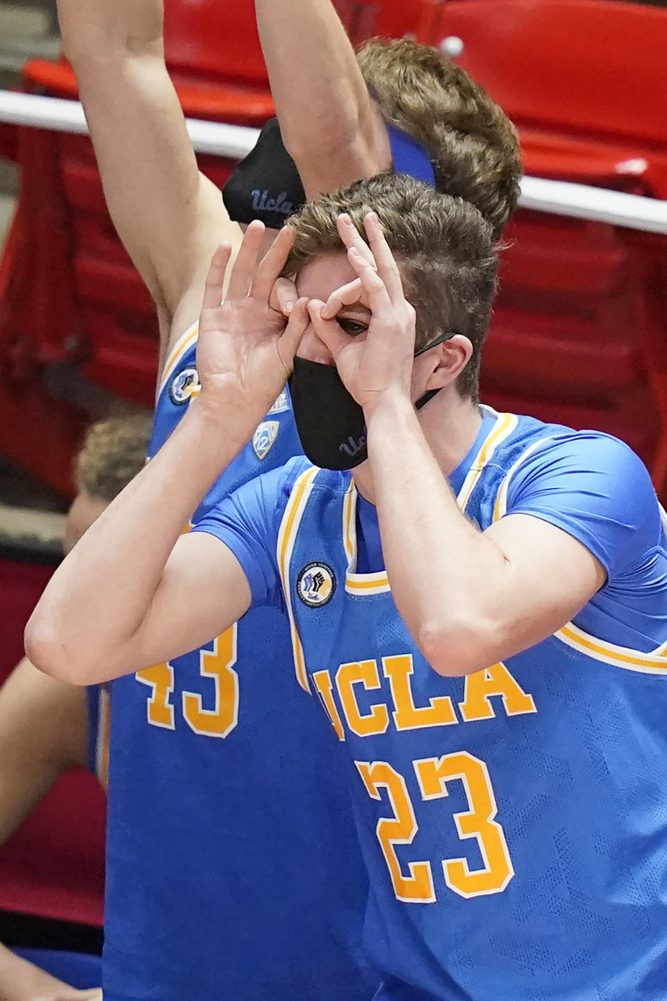 UCLA forward Logan Cremonesi (23) celebrates a teammate's 3-pointer during the second half of an NCAA college basketball game against Utah on Thursday, Feb. 25, 2021, in Salt Lake City. (AP Photo/Rick Bowmer)