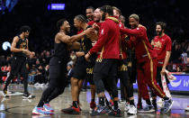 Cleveland Cavaliers guard Donovan Mitchell, front left, congratulates forward Isaac Okoro, second from front left, after making the winning basket against the Brooklyn Nets during the second half of an NBA basketball game, Thursday, March 23, 2023, in New York. (AP Photo/Noah K. Murray)
