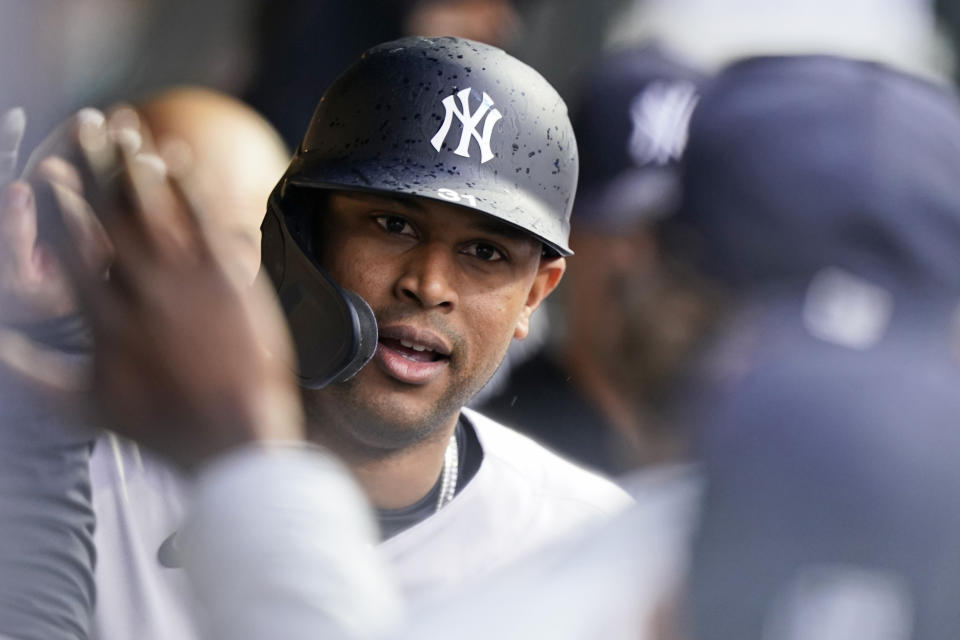 New York Yankees' Aaron Hicks is congratulated by teammates after hitting a solo home run in the fifth inning of a baseball game against the Cleveland Indians, Saturday, April 24, 2021, in Cleveland. (AP Photo/Tony Dejak)