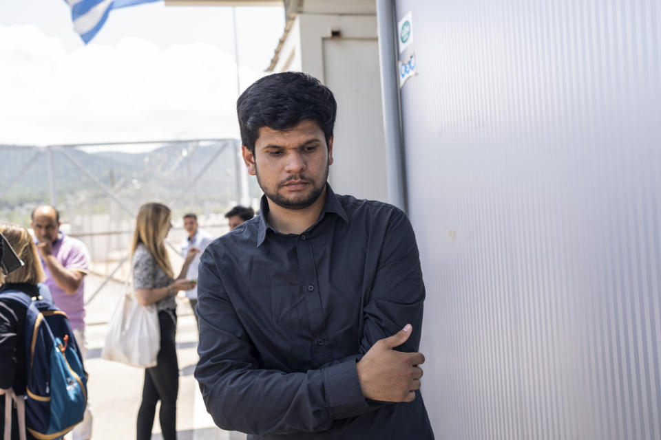 Zohaib Shamraiz stands outside a migrant camp while looking for his missing uncle, Nadeem Muhamm, in Malakasa north of Athens, on Monday, June 19, 2023. Hundreds of migrants are believed to be missing after a fishing trawler sank off southern Greece last week. (AP Photo/Petros Giannakouris)