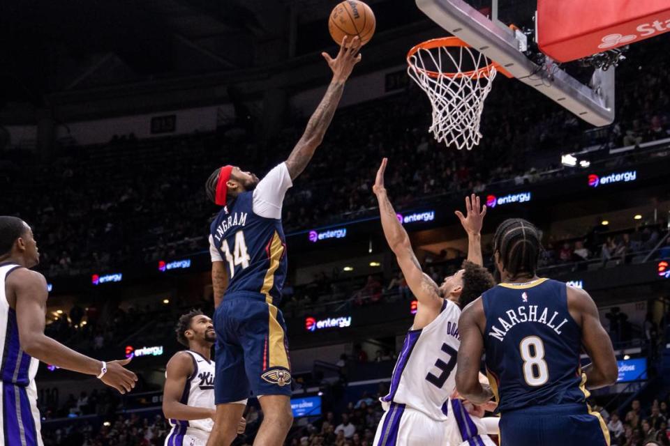New Orleans Pelicans forward Brandon Ingram (14) drives to the basket against Sacramento Kings guard Chris Duarte (3) Wednesday in New Orleans.