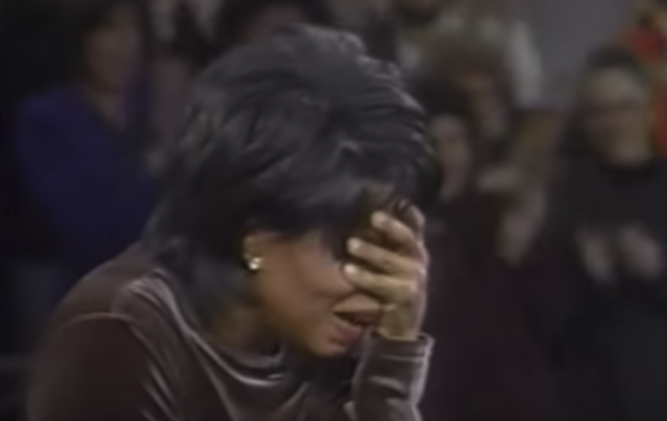 Oprah looking shocked with her hand over her eyes