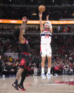 Washington Wizards' Corey Kispert shoots over Chicago Bulls' Coby White during the first half of an NBA basketball game Monday, March 25, 2024, in Chicago. (AP Photo/Charles Rex Arbogast)