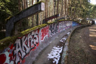 Graffiti covers the destroyed bobsleigh track on Trebevic mountain near Sarajevo, Bosnia, Wednesday, Feb. 7, 2024. The bobsleigh track area was a Bosnian-Serb artillery stronghold during the war 1992-1995 Bosnian war. Sarajevo is paying tribute this week to one of its most glorious moments: the two weeks of February in 1984 when it staged an impeccable Winter Olympic Games. While taking the nostalgic trip down memory lane, Bosnian Olympians say they are looking to the future with hope to again pull off an “apparently impossible feat” and reignite the Olympic flame over Sarajevo in 2032. (AP Photo/Armin Durgut)