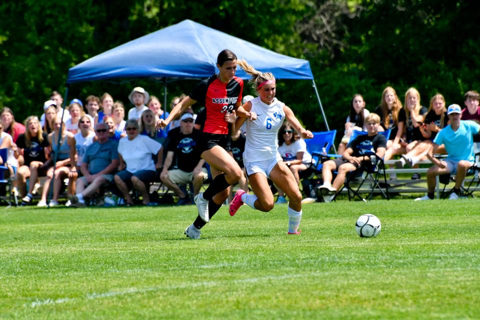 Van Meter's Eden Moore fights for control of the ball against Davenport Assumption's Piper Seberg during the 1A girls state quarterfinal on Wednesday, May 31, 2023, at Cownie Soccer Complex in Des Moines.