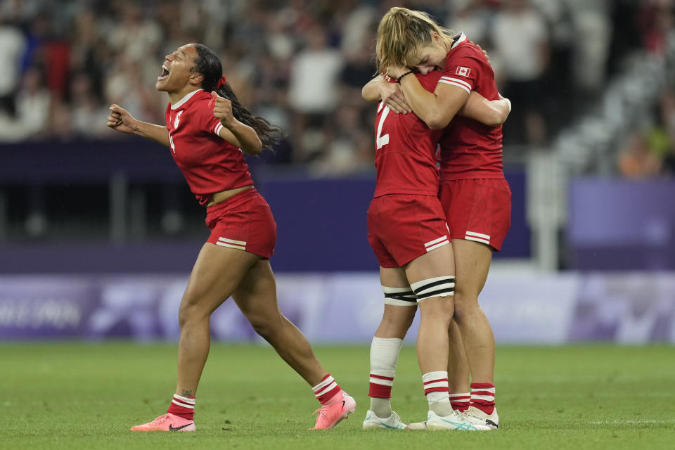 Canada's Asia Hogan-Rochester , left reacts after winning their women's quarterfinal Rugby Sevens match between France and Canada at the 2024 Summer Olympics, in the Stade de France, in Saint-Denis, France, Monday, July 29, 2024. Canada won the game 19-14. (AP Photo/Tsvangirayi Mukwazhi)