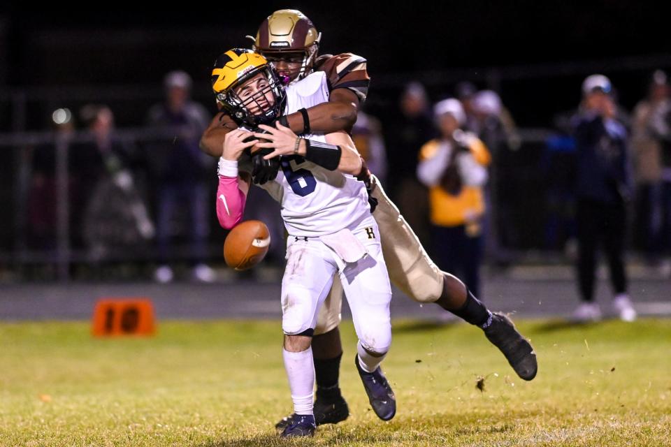 Holt's Carloes Speed sacks Hartland's James Butzier causing a fumble during the fourth quarter on Friday, Oct. 28, 2022, at Holt High School.