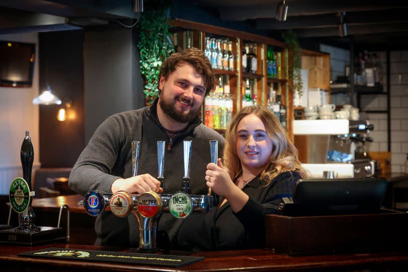 Licensees Jake White and Charlie Clipstone pictured behind the bar at the Four Bells Inn in Main Street, Woodborough.