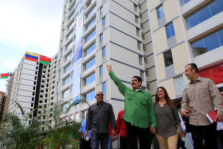 Venezuela's President Nicolas Maduro waves as he arrives for an event for handing over houses, next to Venezuela's Communications minister Jorge Rodriguez, his wife Cilia Flores and Venezuela's Vice President Tareck El Aissami, in Caracas, Venezuela November 23, 2017. Picture taken November 23, 2017. Miraflores Palace/Handout via REUTERS