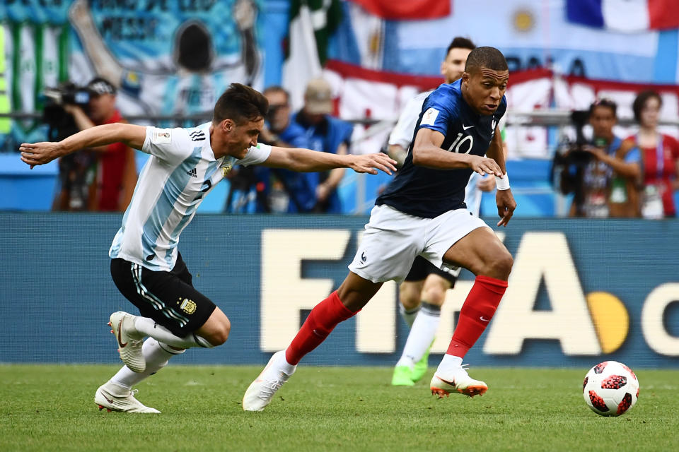 France’s forward Kylian Mbappe (R) is marked by Argentina’s defender Nicolas Tagliafico during the Russia 2018 World Cup round of 16 football match between France and Argentina at the Kazan Arena in Kazan on June 30, 2018. (Getty Images)