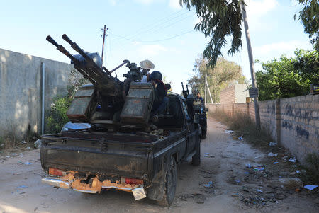 Members of the Libyan internationally recognised government forces ride in military vehicle during a fight with Eastern forces in Ain Zara, Tripoli, Libya April 28, 2019. REUTERS/Ismail Zitouny