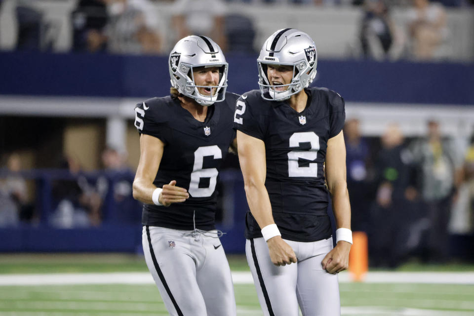 Las Vegas Raiders punter AJ Cole (6) and place kicker Daniel Carlson (2) celebrate after Carlson kicked a 62-yard field goal in the first half of a preseason NFL football game against the Dallas Cowboys in Arlington, Texas, Saturday, Aug. 26, 2023. (AP Photo/Michael Ainsworth)