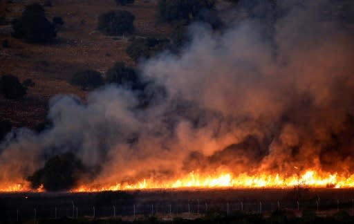 A fire rages in a field in southern Lebanon along the border with Israel on September 1, 2019 after an exchange of fire between Hezbollah and the Israeli army following a week of rising tensions