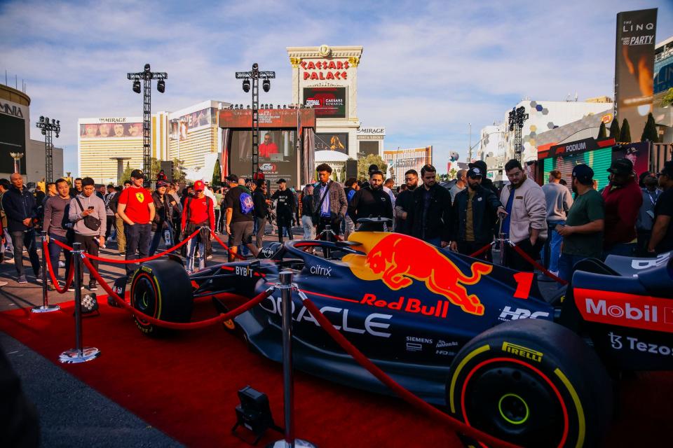 Fans take a look at a Red Bull F1 car outside Caesars Palace, in Las Vegas.