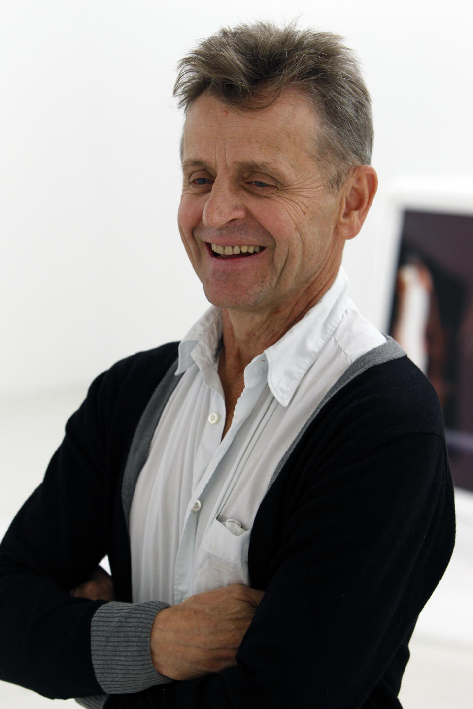 In this Tuesday, Feb. 21, 2012 photo, dancer Mikhail Baryshnikov, laughs as talks about his photographs during an interview with The Associated Press at the Gary Nader Art Centre in Miami. The show, which opens Friday, Feb. 24, is titled “Dance This Way” and features large-scale photographs of ethnic, hip-hop, ballet, modern and popular dances performed on stage by professionals and in nightclubs by amateurs. (AP Photo/Wilfredo Lee)