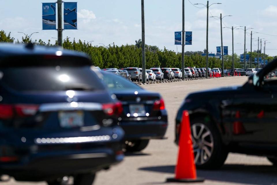 A long line of cars forms as people arrive to the Miami Dade College North vaccination site in Miami, Florida to try and receive a COVID-19 vaccine on Sunday, March 7, 2021.