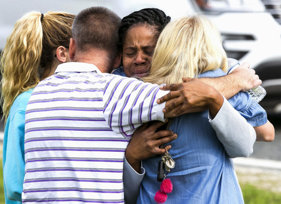 <p>Nikki Brown, center, hugs others in front of Forest High School Friday, April 20, 2018 in Ocala, Fla. (Photo: Doug Engle/Star-Banner via AP) </p>