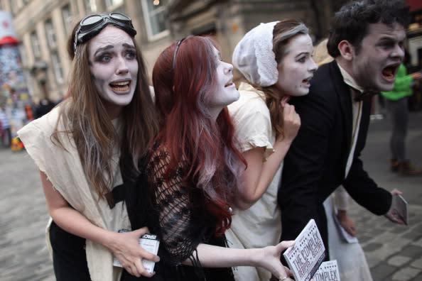 Street entertainers perform on the Royal Mile to promote their shows during in the Edinburgh Fringe Festival on August 6, 2012 in Edinburgh, Scotland. The Edinburgh Festival Fringe is the largest arts festivals in the world, it was established as an alternative to the International Festival also held in August, and celebrates it's 66th anniversary this year. (Photo by Dan Kitwood/Getty Images)