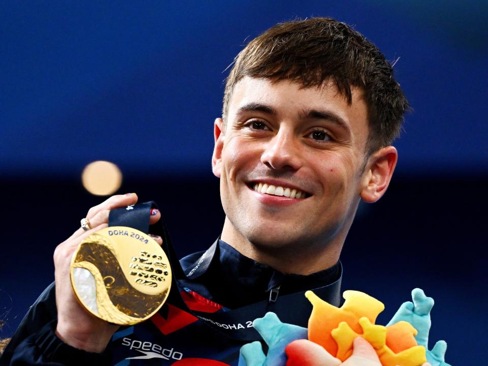 Tom Daley poses with his medal at the Doha 2024 World Aquatics Championship.