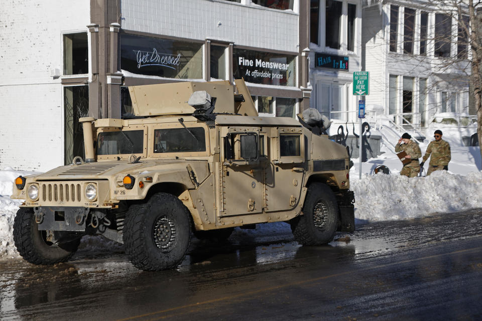 National guard members check on residents, Wednesday, Dec. 28, 2022, in Buffalo N.Y., following a winter storm. (AP Photo/Jeffrey T. Barnes)