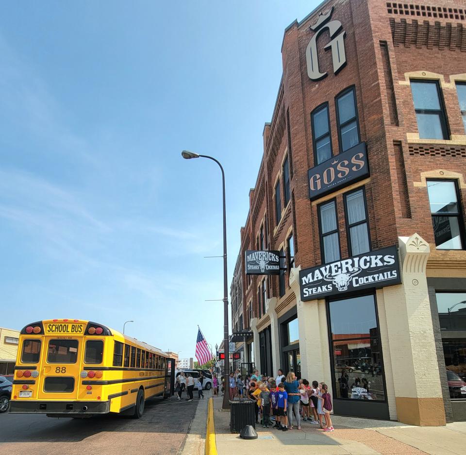 Students wait to load into their school buses after the event at The Goss.