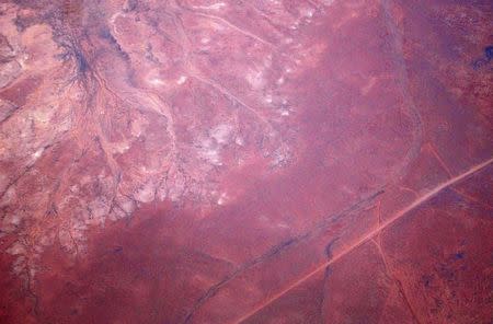 A road can be seen next to dried-up creeks and salt pans located in outback Australia in this aerial picture taken on December 13, 2015. REUTERS/David Gray