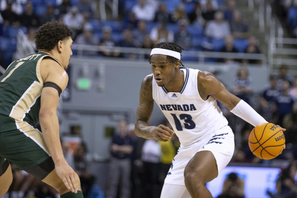 Nevada guard Kenan Blackshear (13) drives against Colorado State guard Nique Clifford (10) during the second half of an NCAA college basketball game Wednesday, Jan. 24, 2024, in Reno, Nev. (AP Photo/Tom R. Smedes)