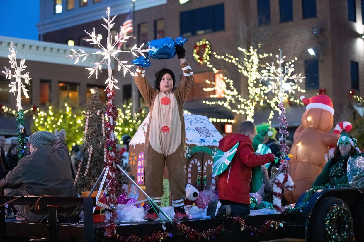 A child holds up a giant piece of candy during last year's Massillon’s holiday parade. This year's parade steps off at 5 p.m. Nov. 19. The light up celebration follows in Duncan Plaza.