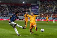 Ecuador's Angelo Preciado, left, kicks the ball past Daley Blind of the Netherlands during the World Cup group A soccer match between Netherlands and Ecuador, at the Khalifa International Stadium in Doha, Qatar, Friday, Nov. 25, 2022. (AP Photo/Natacha Pisarenko)