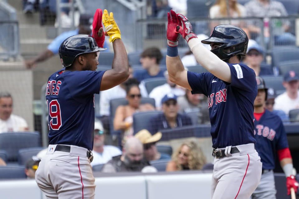 Boston Red Sox's Connor Wong, right, and Pablo Reyes celebrate after scoring off of Wong's two-run home run in the fourth inning of a baseball game against the New York Yankees, Saturday, Aug. 19, 2023, in New York. (AP Photo/Mary Altaffer)