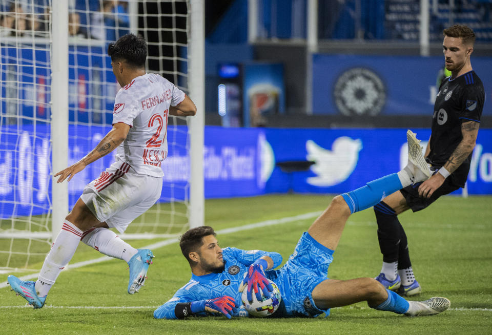 CF Montreal goalkeeper James Pantemis makes a save against New York Red Bulls' Omir Fernandez, left, during the second half of an MLS soccer match Wednesday, Aug. 31, 2022, in Montreal. (Graham Hughes/The Canadian Press via AP)