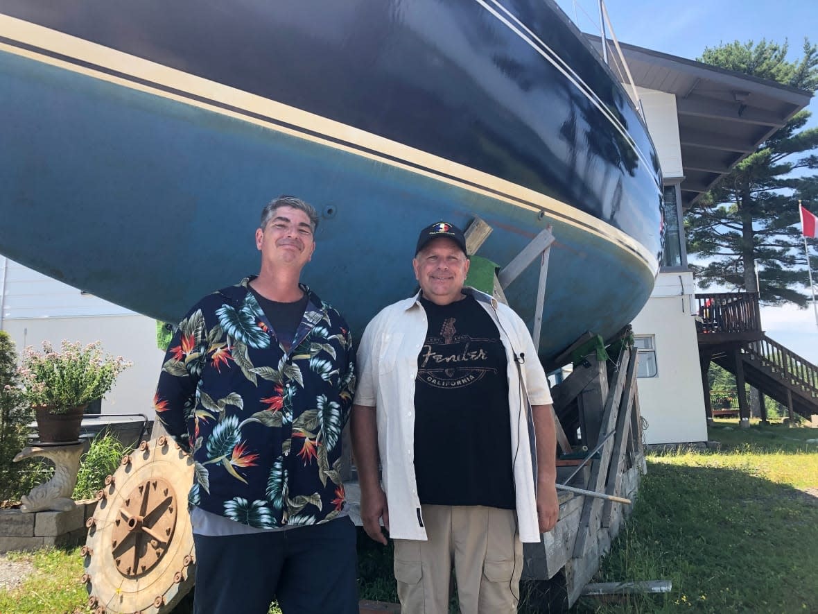 Bill Nickerson and Richard MacLeod hope to mend relations with the neighbouring yacht club and get their boat back on the water.  (Jon Tattrie/CBC - image credit)