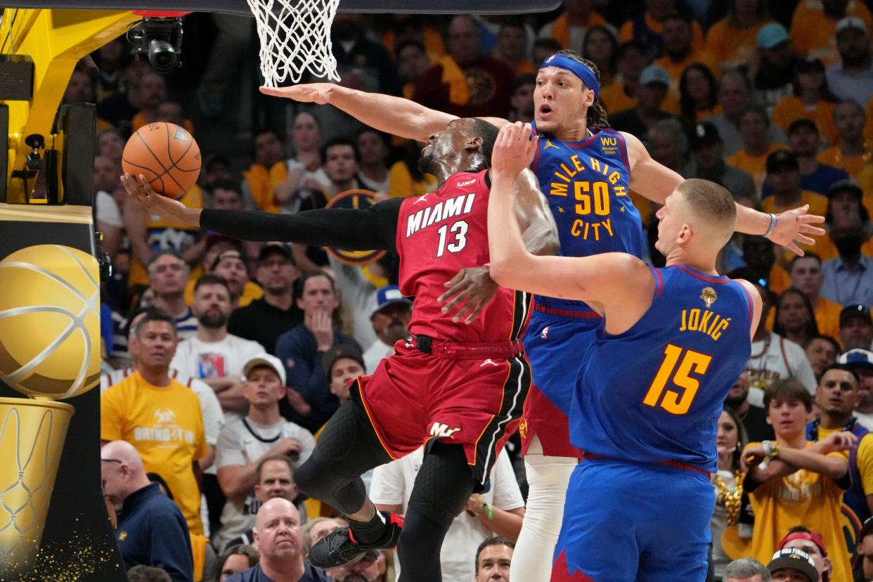 Game 1: Miami Heat center Bam Adebayo shoots the ball against Denver Nuggets forward Aaron Gordon (50) during the third quarter.