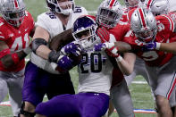 Northwestern running back Cam Porter (20) struggles for yardage during the first half of the Big Ten championship NCAA college football game against Ohio State, Saturday, Dec. 19, 2020, in Indianapolis. (AP Photo/AJ Mast)