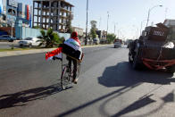 <p>A man rides a bicycle with Iraqi flag in north of Kirkuk, Iraq, Oct. 19, 2017. (Photo: Ako Rasheed/Reuters) </p>