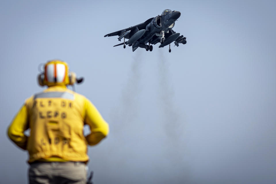 In this photo released by the U.S. Marine Corps, a sailor on the amphibious assault ship USS Bataan directs a Marine Corps AV-8B Harrier II jet in the Gulf of Oman, Monday, Aug. 14, 2023. The Bataan transited through the Strait of Hormuz, the narrow mouth of the Persian Gulf, in recent days amid tensions with Iran, U.S. Navy Cmdr. Rick Chernitzer said Sunday, Aug. 20, 2023. (Sgt. Matthew Romonoyske-Bean/U.S. Marine Corps via AP)