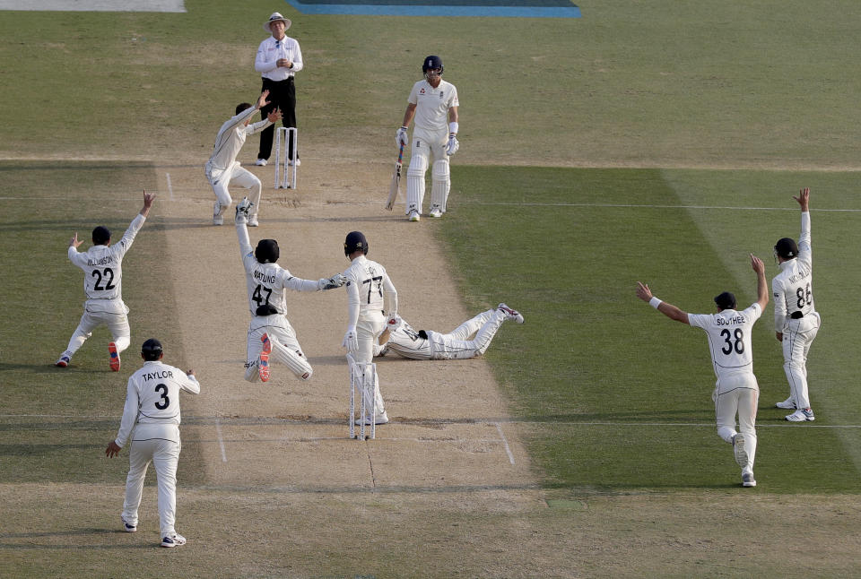 New Zealand players celebrate the dismissal of England's Jack Leach, 77, during play on day four of the first cricket test between England and New Zealand at Bay Oval in Mount Maunganui, New Zealand, Sunday, Nov. 24, 2019. (AP Photo/Mark Baker)