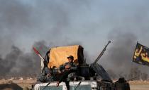 <p>Iraqi special forces members rests during a battle with Islamic State fighters on the outskirts of Mosul, Iraq, February 25, 2017. (Goran Tomasevic/Reuters) </p>