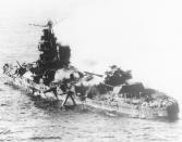 FILE - In this May, 1942, file photo, a Japanese heavy cruiser of the Mogami class lies low in the water after being bombed by U.S. naval aircraft during the Battle of Midway. The Pacific War was so massive and so calamitous that it can be difficult to put it in context. There was the Marco Polo Bridge Incident that triggered the Sino-Japanese War, the Battle of Midway that changed the course of the war and the dramatic flag-raising on Iwo Jima. (AP Photo/File)