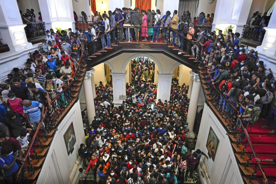 People throng President Gotabaya Rajapaksa’s official residence for the second day after it was stormed in Colombo, Sri Lanka, Monday, July 11, 2022. Sri Lanka is in a political vacuum for a second day Monday with opposition leaders yet to agree on who should replace its roundly rejected leaders, whose residences are occupied by protesters, angry over the country's economic woes. (AP Photo/Eranga Jayawardena)