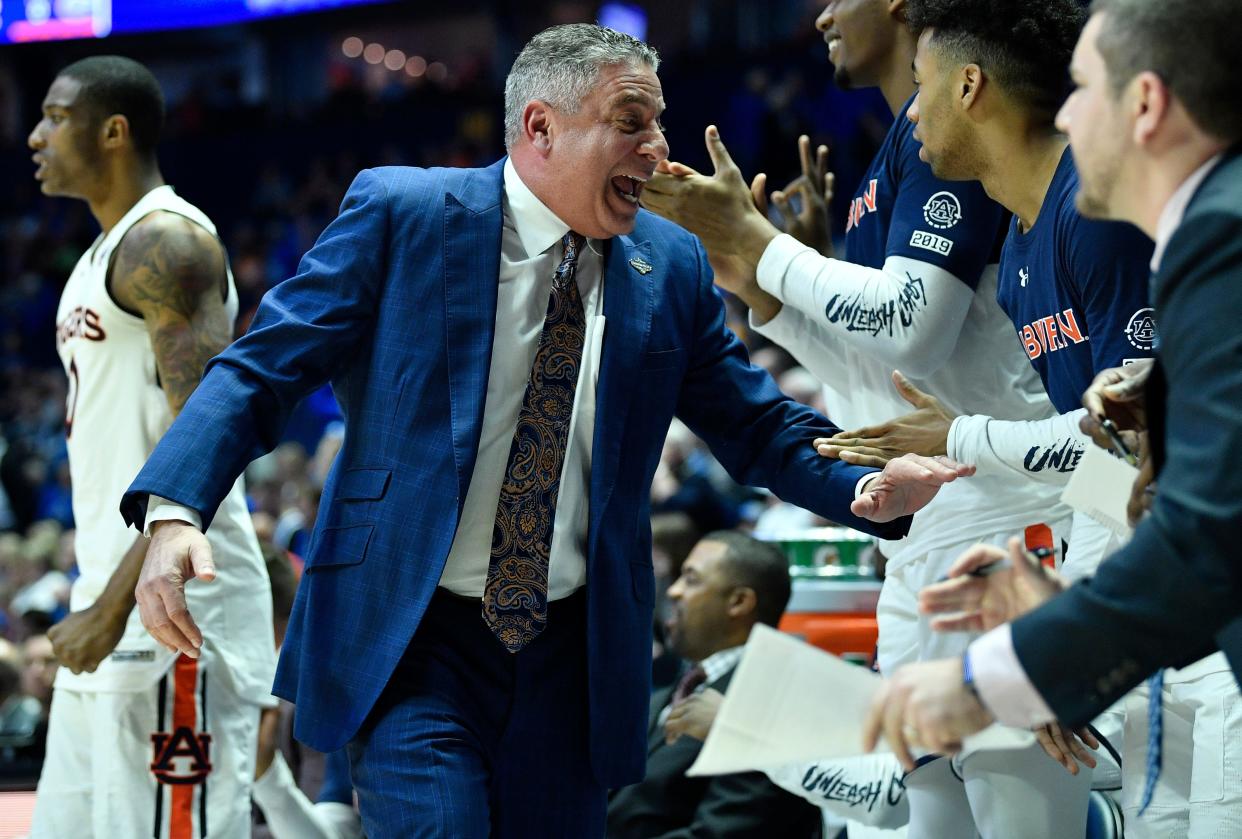 Auburn head coach Bruce Pearl slaps hands during the first half of the SEC Men's Basketball Tournament game against Florida at Bridgestone Arena in Nashville, Tenn., Saturday, March 16, 2019.