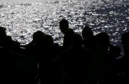 FILE PHOTO: Migrants intercepted aboard a dinghy off the coast in the Strait of Gibraltar, are seen on a rescue boat after arriving at the Port of Algeciras, southern Spain, June 30, 2018. REUTERS/Jon Nazca/File Photo