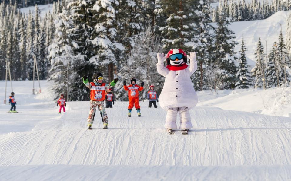 Children learning to ski at the Trysil centre's fun ski academy, with Valle the snowman