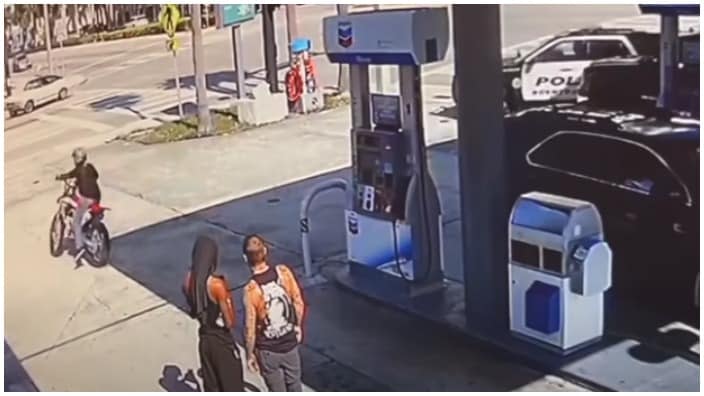 Stanley Davis is seen on his dirt bike at a gas station in Boynton Beach — as are local police. (Photo: Screenshot/YouTube)