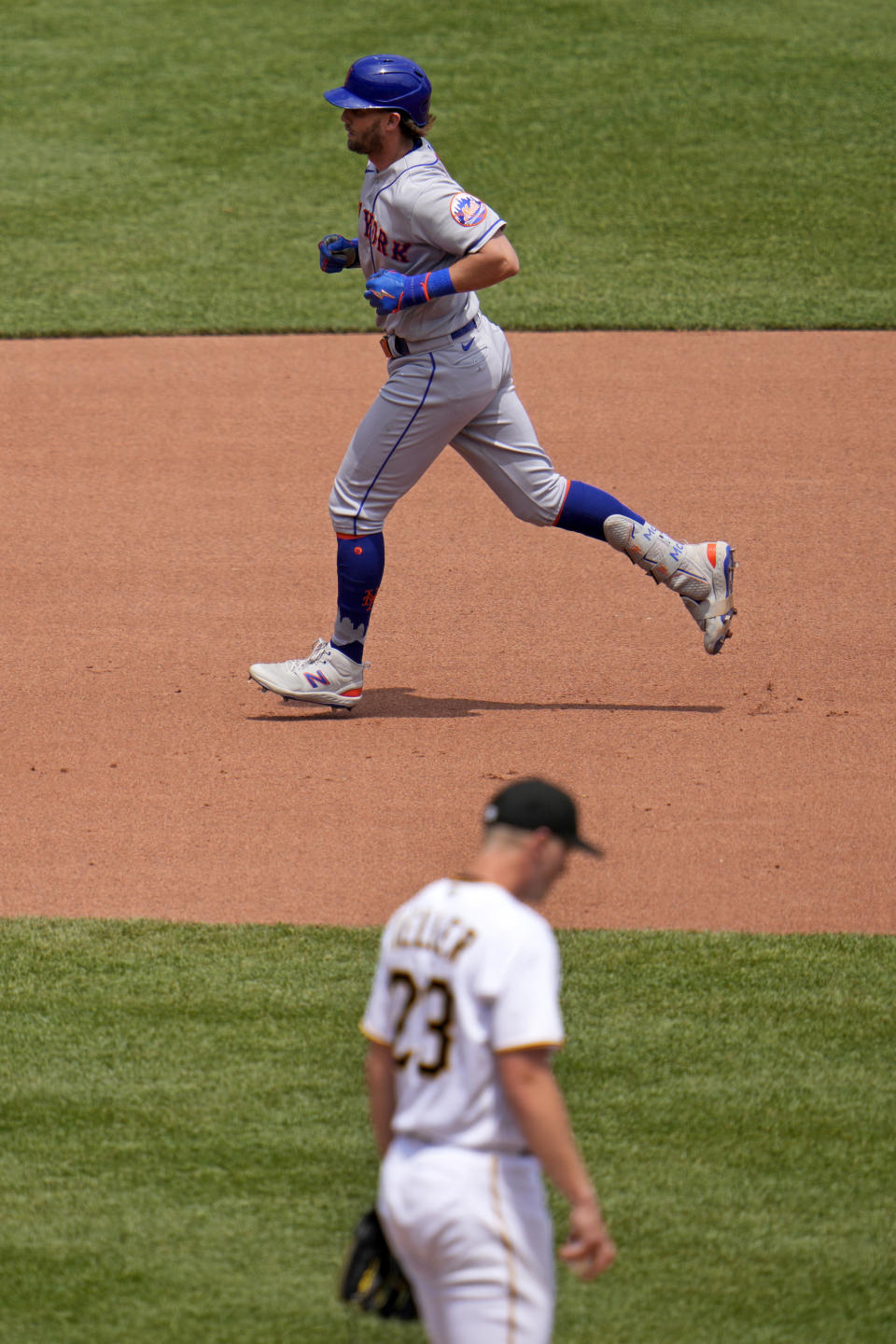 New York Mets' Jeff McNeil, top, rounds the bases after hitting a solo home run off Pittsburgh Pirates starting pitcher Mitch Keller, bottom, during the fourth inning of a baseball game in Pittsburgh, Sunday, June 11, 2023. (AP Photo/Gene J. Pusk