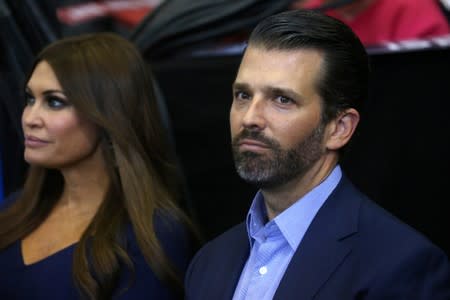 Donald Trump Jr., son of U.S. President Donald Trump, and Kimberly Guifoyle listen during a campaign rally in Cincinnati